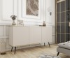 Beżowa komoda glamour Oro K160 na czarnych nogach w eleganckim salonie