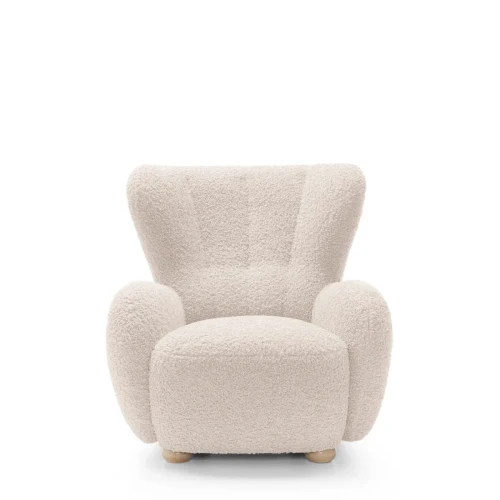 Beżowy fotel wypoczynkowy Ciro boucle prezentujący nowoczesny, obły design i wysokie oparcie.