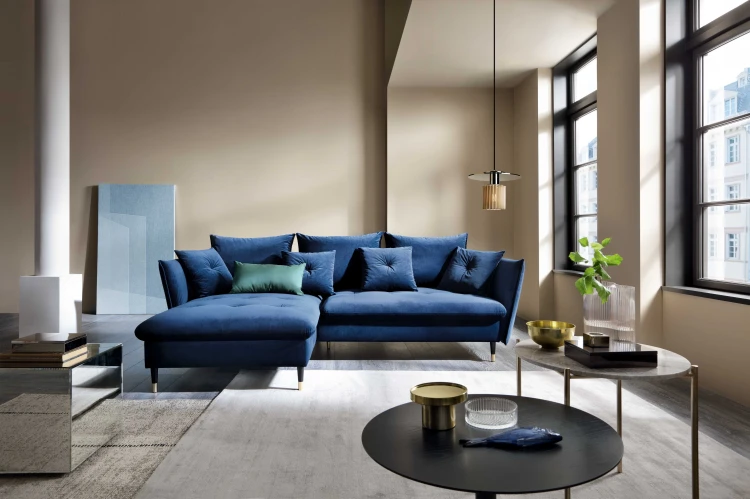 Granatowy velvetowy narożnik Glam w eleganckim salonie modern classic jako główny element strefy wypoczynkowej.