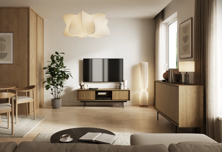 Elegancka szafka pod telewizor Deco RTV150 Baltic Dune zaaranżowana w nowoczesnym salonie z telewizorem wiszącym na ścianie i robotem sprzątającym przejeżdżającym pod meblem.