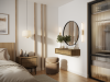 Elegancki stolik nocny Deco SN Baltic Dune zaaranżowany w nowoczesnej sypialni obok łóżka, z postawioną lampką nocną i robotem odkurzającym czyszczącym podłogę pod meblem.